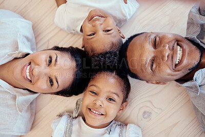 Buy stock photo Happy, smile and portrait of family on floor with top view for bonding, support or relax in living room. Funny, playing and affection with face of parents and children on ground at home for happiness