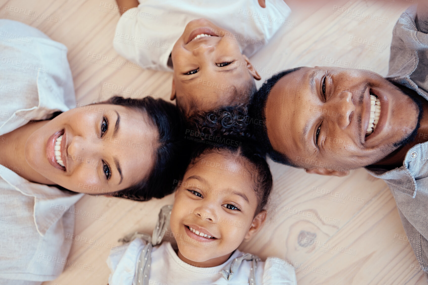 Buy stock photo Happy, smile and portrait of family on floor with top view for bonding, support or relax in living room. Funny, playing and affection with face of parents and children on ground at home for happiness