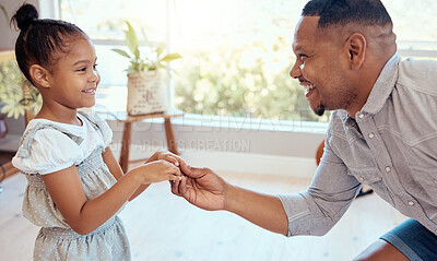 Buy stock photo Black family, love and father dance with girl, having fun and bonding in home. Happy, smile and parent with child holding hands, dancing and playing, care and enjoying quality time together in house.