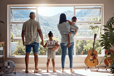 Buy stock photo Family, love and window back view in home looking at mountain. Support, trust and baby, mother and father holding hands of girl in house with scenic view, enjoying quality time together and bonding.