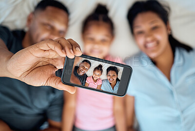 Buy stock photo Phone, selfie and portrait of family on bed for fun, happiness and relaxing in morning. Black family, love and photo on screen of dad using smartphone with mom and girl in bedroom, enjoying weekend