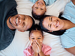 Happy family, portrait and top view in bedroom for love, care or relax in family home. Above of head, face and smile parents, excited children and family time, happiness and bonding together in house