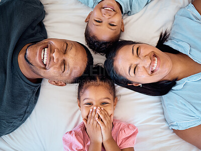 Buy stock photo Happy family, portrait and top view in bedroom for love, care or relax in family home. Above of head, face and smile parents, excited children and family time, happiness and bonding together in house