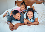 Happy family with kids, smile and lying on bed in home, mother and father with children together in Mexico. Love, fun and family time for dad, mom and babies playing in family bedroom on weekend.