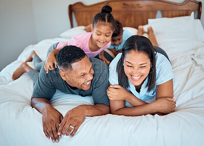 Buy stock photo Happy family with kids, smile and lying on bed in home, mother and father with children together in Mexico. Love, fun and family time for dad, mom and babies playing in family bedroom on weekend.