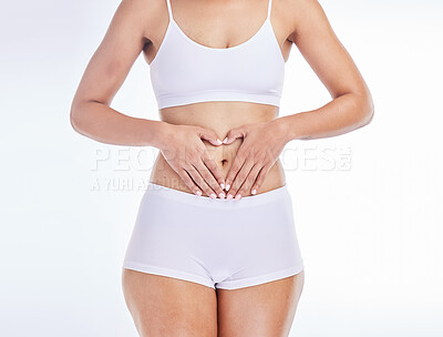 Buy stock photo Health, heart and hands on woman stomach for training, nutrition and balance gut wellness. Menstruation, digestion and fitness with girl body for diet, probiotics or hair removal in white background 