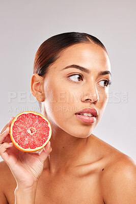 Buy stock photo Skincare, beauty woman with grapefruit in hand for wellness healthcare, cosmetic health or skin luxury in studio. Face of girl skin, healthy diet with vitamins, food or fruit for nutrients
