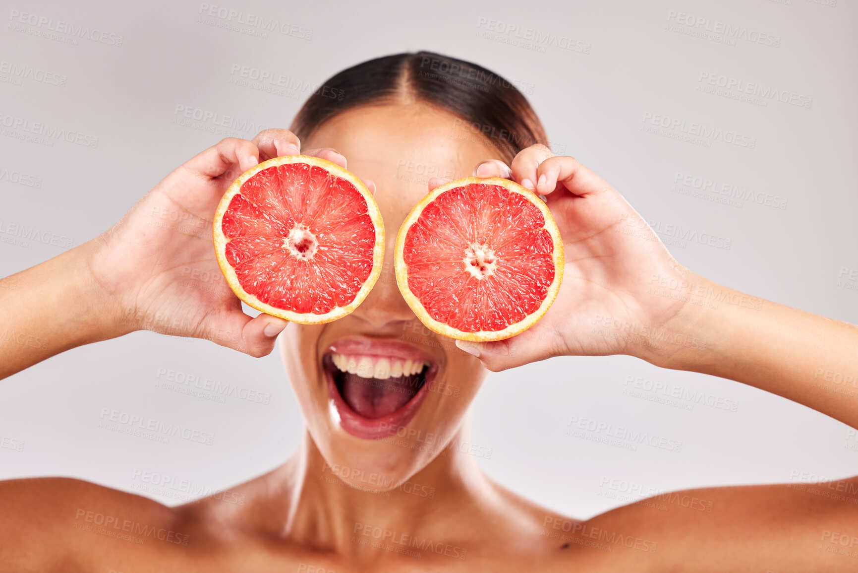 Buy stock photo Face, skincare and grapefruit in woman hands in studio portrait for facial eco friendly, vegan or healthy product marketing or advertising space. Happy model with vitamin c fruits for skin care glow