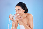 Skincare, cleaning and water splash on face of black woman for beauty, wellness and facial. Spa, luxury and shower with girl model and hands of water drop for health, self care and dermatology