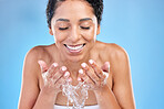 Splash, water and black woman for facial skincare, cleaning or healthy glow promotion on blue studio mockup. Beauty, skin care and wellness model with water in hands for face cosmetic clean wash care