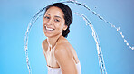 Beauty, splash and black woman in studio portrait for cleaning body or skincare promotion with water on blue mockup. Face, skin care model with water drops or shower in bathroom for morning facial