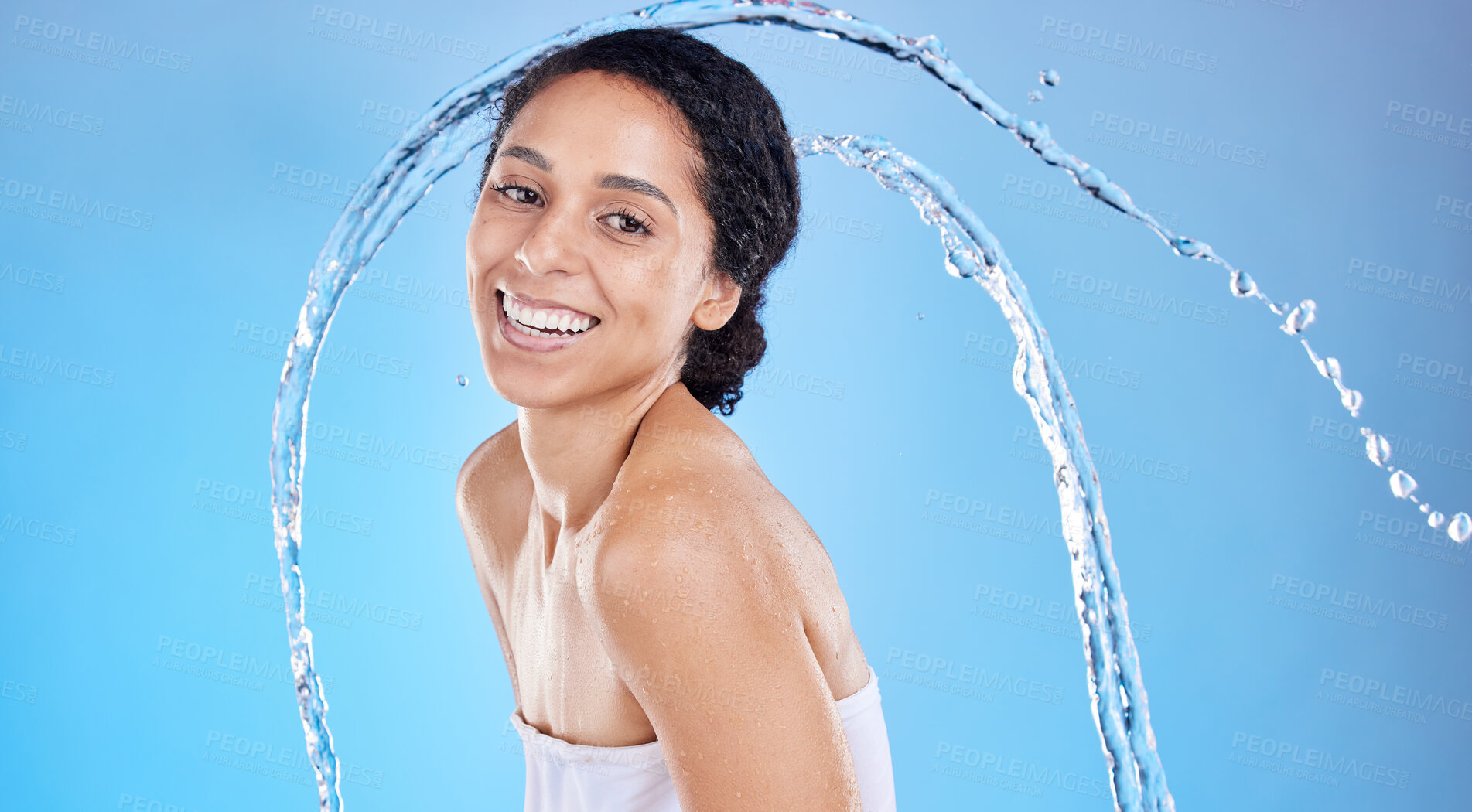 Buy stock photo Beauty, splash and black woman in studio portrait for cleaning body or skincare promotion with water on blue mockup. Face, skin care model with water drops or shower in bathroom for morning facial