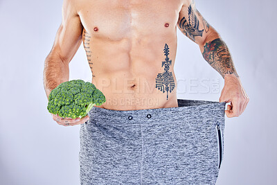 Buy stock photo Vegetable, diet and weight loss, man on health detox and workout exercise for healthy lifestyle on studio background. Fitness, nutrition and wellness for balance in body, male model with tattoo.