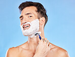 Skincare, shaving and face foam man with facial razor for hair removal, beauty and grooming marketing. Wellness, self care and beard cosmetic model with blue studio advertising mock up.

