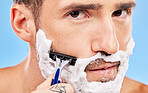 Shaving face, hair removal and man with razor in grooming and hygiene portrait, cream on beard to clean and beauty with studio background. Foam, moisturizer and cleaning with skincare and wellness.