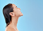 Shower, clean and woman with water for hygiene and grooming with beauty and skincare against blue studio background. Cleaning mockup, wet and hair care with wellness and water drops when washing.