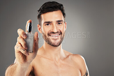 Buy stock photo Man, face or body care cologne bottle on gray studio background for morning grooming routine, aroma fragrance or scent spray. Portrait, smile or happy male perfume model and parfume product container