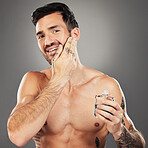 Man, aftershave and skincare portrait for face and beard on a grey studio background for wellness and beauty. Skin care, cologne and man apply product to face for grooming, clean facial hair