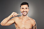 Dental hygiene, man and brushing teeth for health, wellness and body care against grey background. Portrait, oral health and male with toothbrush, fresh breath and healthy with smile and toothpaste.