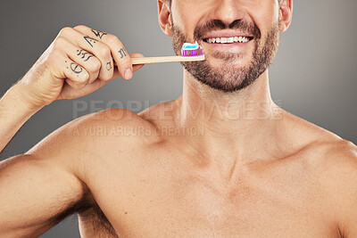 Health, dental or man with toothbrush for teeth, dental hygiene or happy face on a grey studio background. Oral, smile or face zoom portrait of healthy male with brush for healthcare wellness model