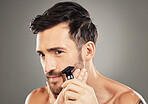 Thinking, shaving and man with a razor for his face, skincare and beauty against a grey studio background. Cosmetic, clean and man with an idea for healthy beard, facial hair and health of skin