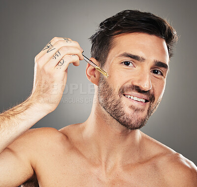 Buy stock photo Skincare, health and portrait of man with serum on face for anti aging and glowing skin on studio background. Beauty, facial and male model with liquid oil product in pipette for wrinkles treatment.