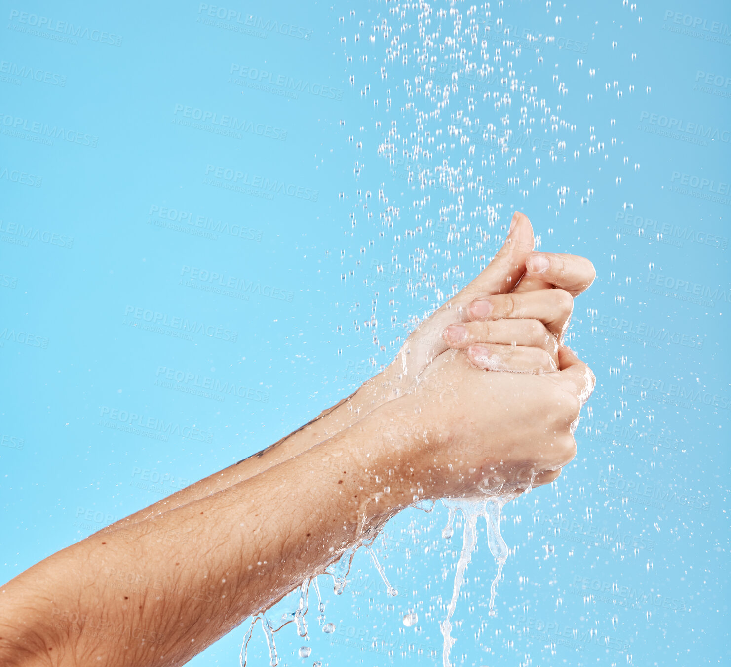 Buy stock photo Woman, water splash or washing hands on blue background in studio for hygiene maintenance, bacteria security safety or grooming. Zoom, model or wet cleaning in shower skincare wellness and healthcare