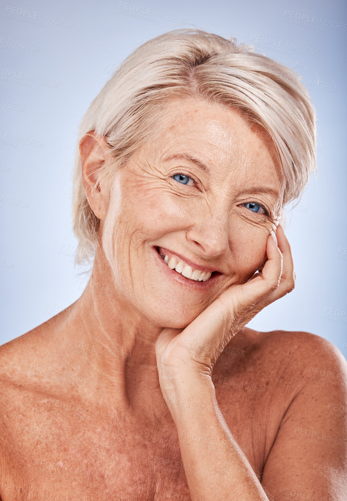 Buy stock photo Portrait, cosmetics and senior woman with natural beauty, skincare and wellness for health on blue studio background. Makeup, mature lady or elderly female with smile, face detox and smooth skin care