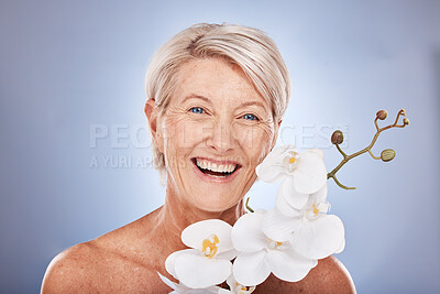 Buy stock photo Face, beauty and flowers with a mature woman in studio on a gray background with an orchid for natural care. Portrait, cosmetics and plant with a senior female posing to promote the benefit of nature