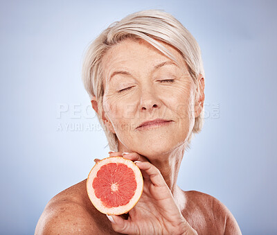 Buy stock photo Mature woman, fruit and skincare, beauty and health for vitamin c anti aging, fresh skin care and body care on a grey studio background. Citrus, grapefruit and antioxidants for organic treatment
