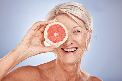 Buy stock photo Beauty, mature woman and grapefruit portrait with a woman for skincare and wellness on a grey studio background. Cosmetic, fruit and citrus with fresh food for healthy skin care and anti aging 