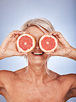 Senior, fruit and health of a woman with grapefruit, healthy food and nutrition product. Wellness, skincare and natural skin care of elderly face with happiness about detox diet and cosmetic beauty 