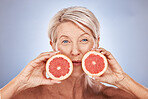 Natural, portrait and senior wellness with grapefruit for skin, beauty and aging treatment. Skincare, mature and health model for vitamin c fruit cosmetic advertising with gray studio mockup.
