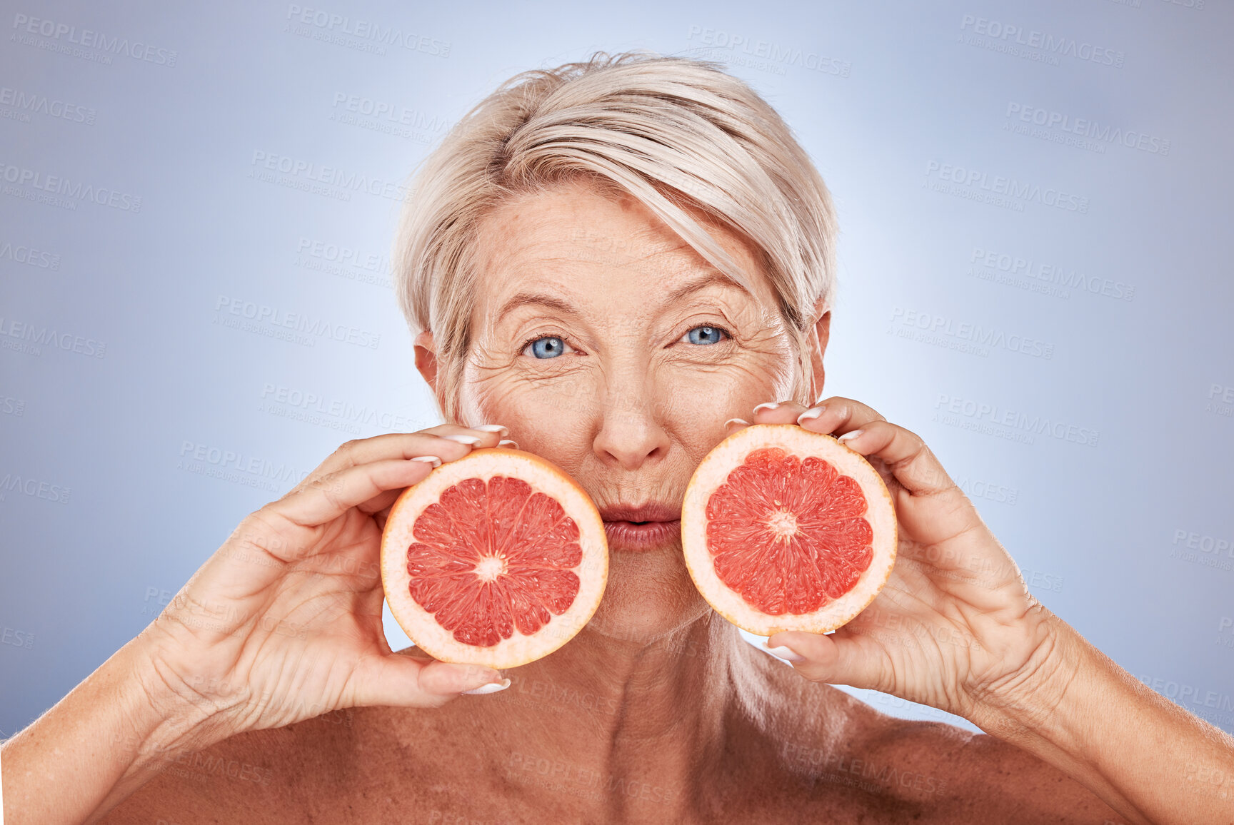 Buy stock photo Natural, portrait and senior wellness with grapefruit for skin, beauty and aging treatment. Skincare, mature and health model for vitamin c fruit cosmetic advertising with gray studio mockup.