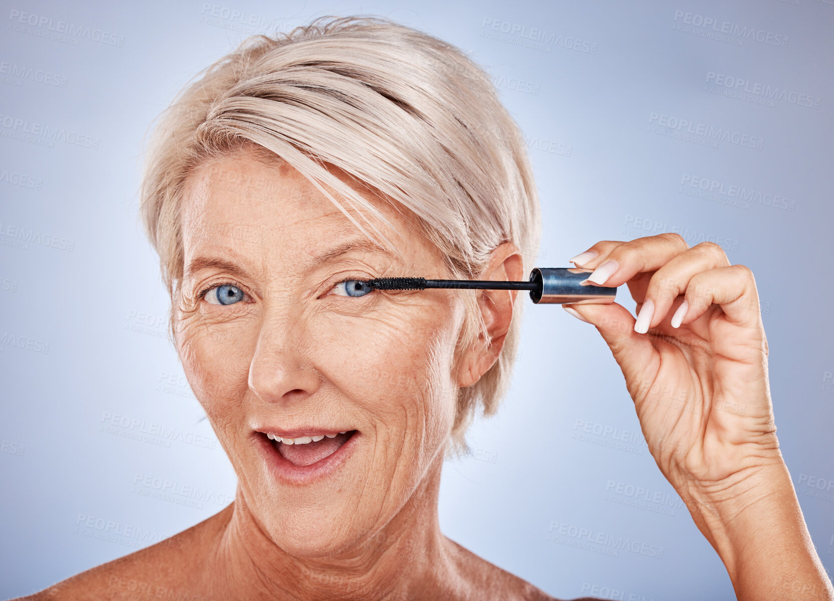 Buy stock photo Makeup, mascara and portrait of a senior woman with a natural, cosmetic and beauty routine in a studio. Cosmetics, beautiful and elderly model with a eyelash product isolated by a gray background.