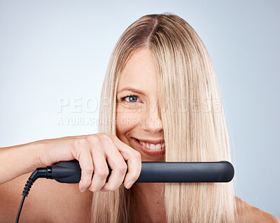 Buy stock photo Hair care, flat iron and woman advertising beauty product, cosmetics and smile on grey mockup studio background. Happy female model, healthy hair and wellness with electronic device or technology