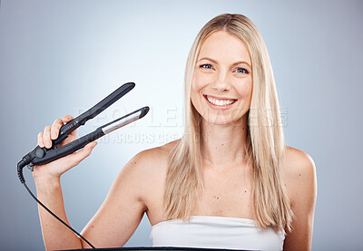Buy stock photo Woman, hair straightener or heat styling tool on gray studio background for hair style, hair care or morning grooming routine. Portrait, smile or happy beauty model and flat iron for smooth treatment