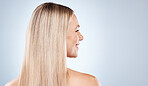 blonde happy woman, with healthy straight hair aesthetic on blue background in studio and flat iron hair care. Young girl with clean hair, side profile beauty with natural shine and luxury shampoo