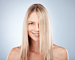 Hair, woman and portrait of blond lady with healthy hair for beauty and haircare. Hair care, hairstyle and face of blonde female for cosmetology or wellness on a grey studio background