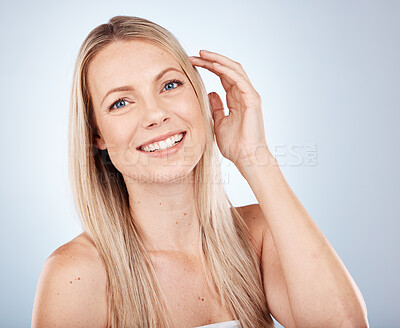 Buy stock photo Health, beauty and straight hair portrait of blonde model feeling smooth, soft and luxury texture. Shine, cosmetic and happy woman satisfied with salon hair care on gray studio mock up.
