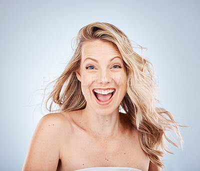 Buy stock photo Woman, excited face or expression and blonde hair in motion on gray studio background in frizz free wavy hairstyle. Portrait, happy smile or wow beauty model and healthy hair care or grooming routine