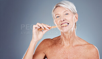Buy stock photo Brushing teeth, portrait and senior woman in studio for dental, mouth and tooth wellness with product marketing, advertising and promotion space. Elderly model with toothbrush for morning care mockup