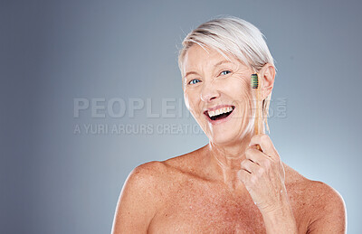 Buy stock photo Dental, wellness and portrait of old woman with toothbrush in hand on gray background studio. Eco friendly, oral hygiene and senior female with bamboo brush for clean teeth, dental care and dentist
