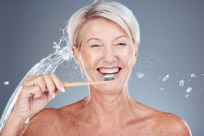 Buy stock photo Wellness, water splash and portrait of old woman brushing teeth isolated on gray background in studio. Bamboo, dental care and senior female cleaning teeth with toothbrush for eco friendly hygiene