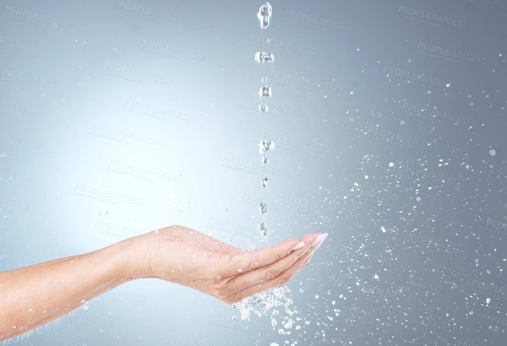 Buy stock photo Water, stream and isolated hand in studio on gray background for wellness, cleaning and hydration. Healthcare, body care and woman cleanse, hydrate and washing hands with water splash for hygiene