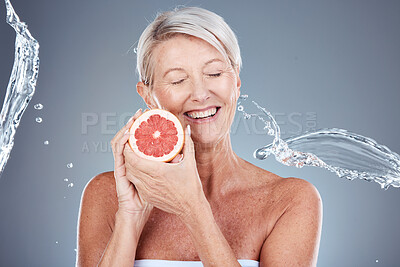 Buy stock photo Wellness, beauty and grapefruit woman with water splash for body care, skincare and health cosmetics marketing. Clean, happy and healthy senior model for cosmetic advertising on gray studio mockup.