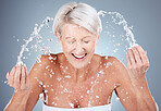Mature woman, water splash or washing face in skincare grooming routine, morning hygiene maintenance or healthcare wellness. Smile, happy or elderly beauty model in facial cleaning and wet water drop