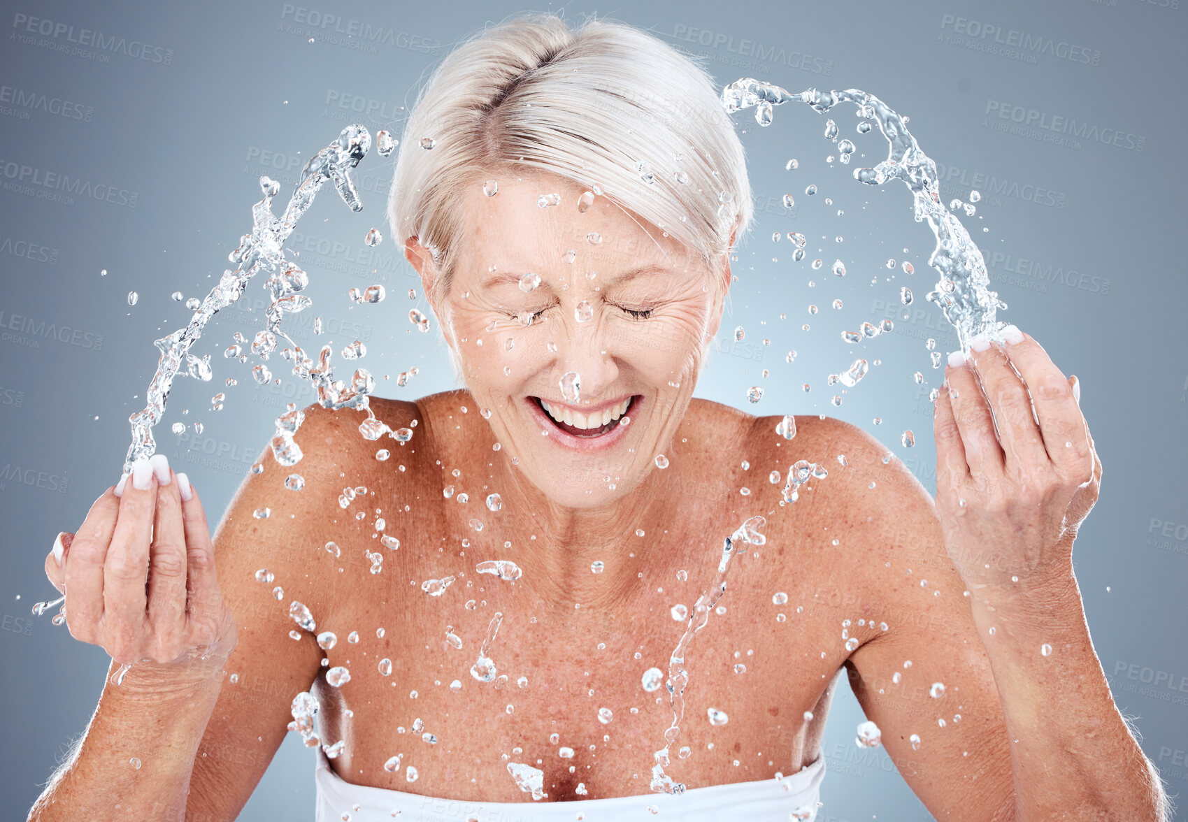 Buy stock photo Mature woman, water splash or washing face in skincare grooming routine, morning hygiene maintenance or healthcare wellness. Smile, happy or elderly beauty model in facial cleaning and wet water drop