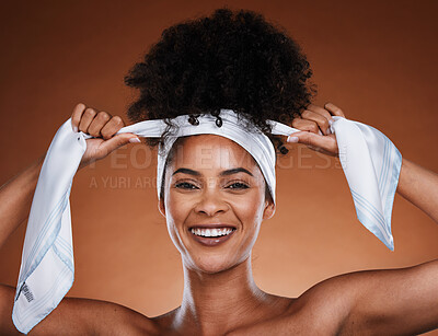 Buy stock photo Black woman, hair scarf and hairstyle with portrait of aesthetic female tying her curly hair on a brown studio background. Afro, hair care and hair style with a lady with hair wrap for healthy hair 