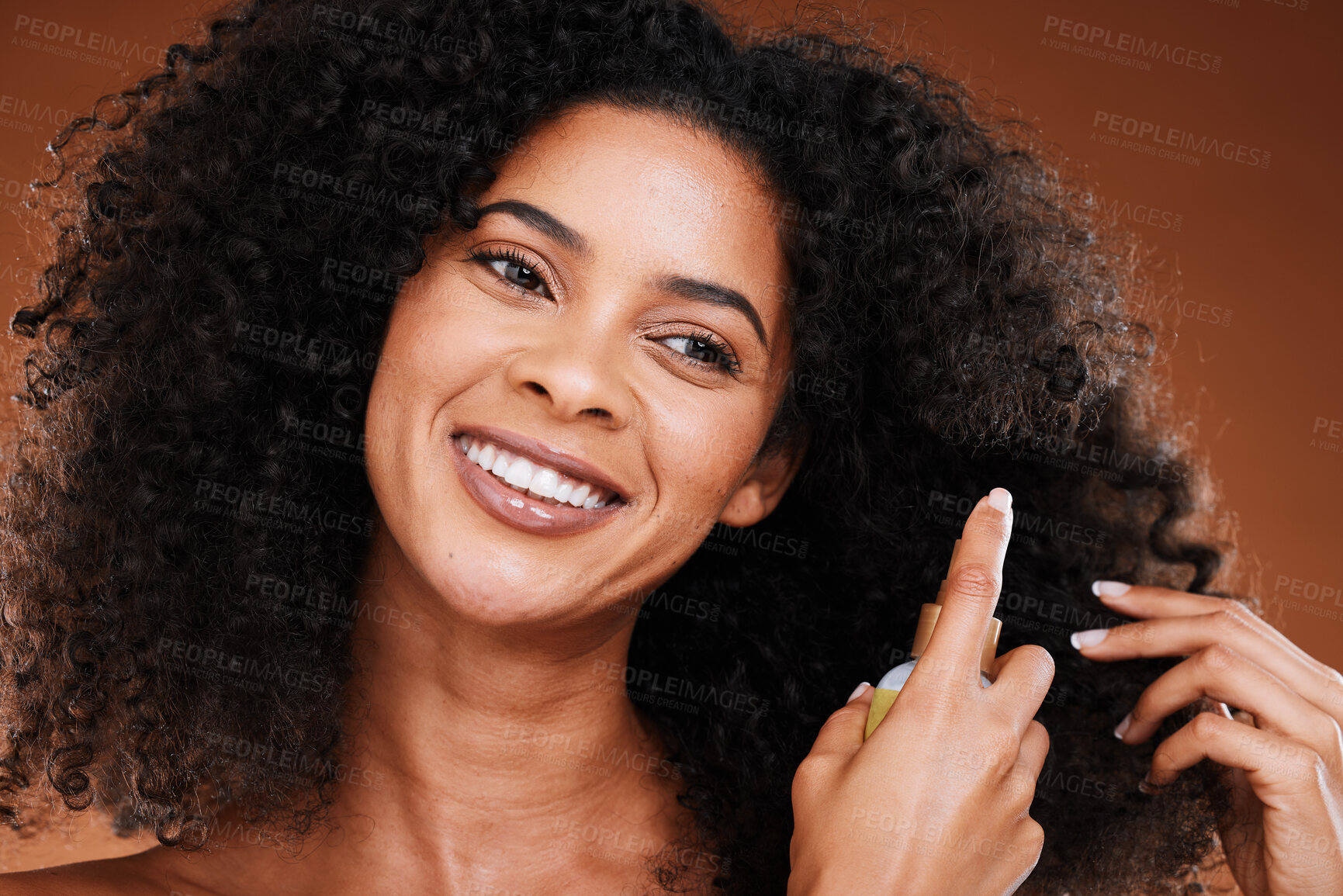 Buy stock photo Black woman, spray and natural hair beauty for shine, healthy and curly texture care bottle. Hair care, happy and oil cosmetic protection product with confident girl model in brown studio.